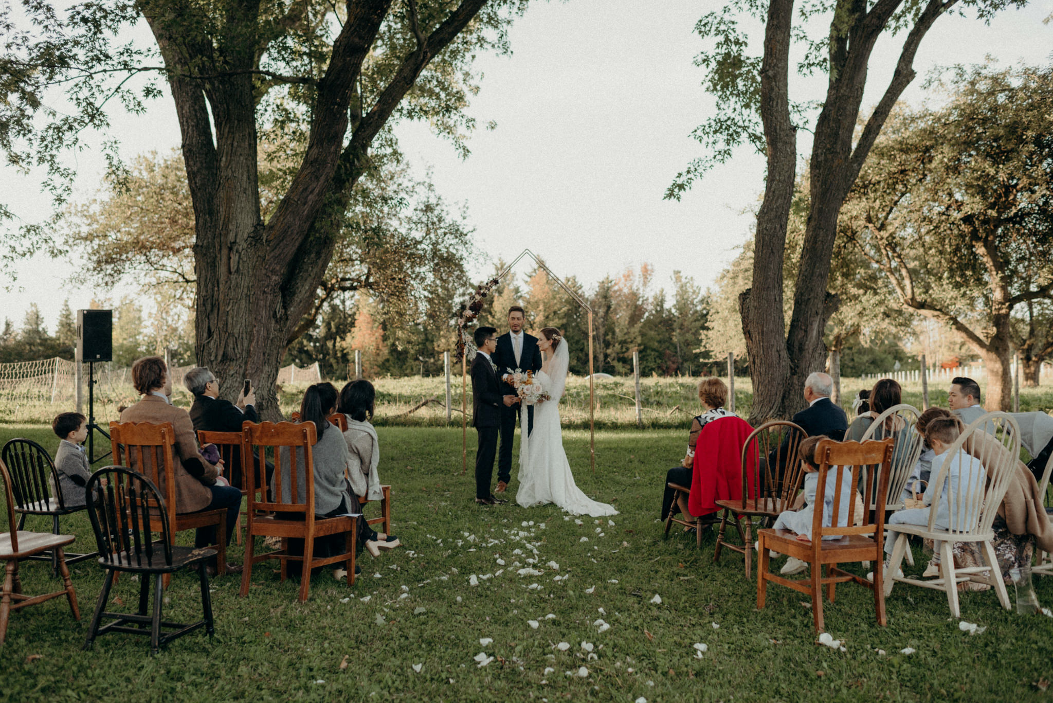 intimate wedding ceremony on the front lawn of farmhouse