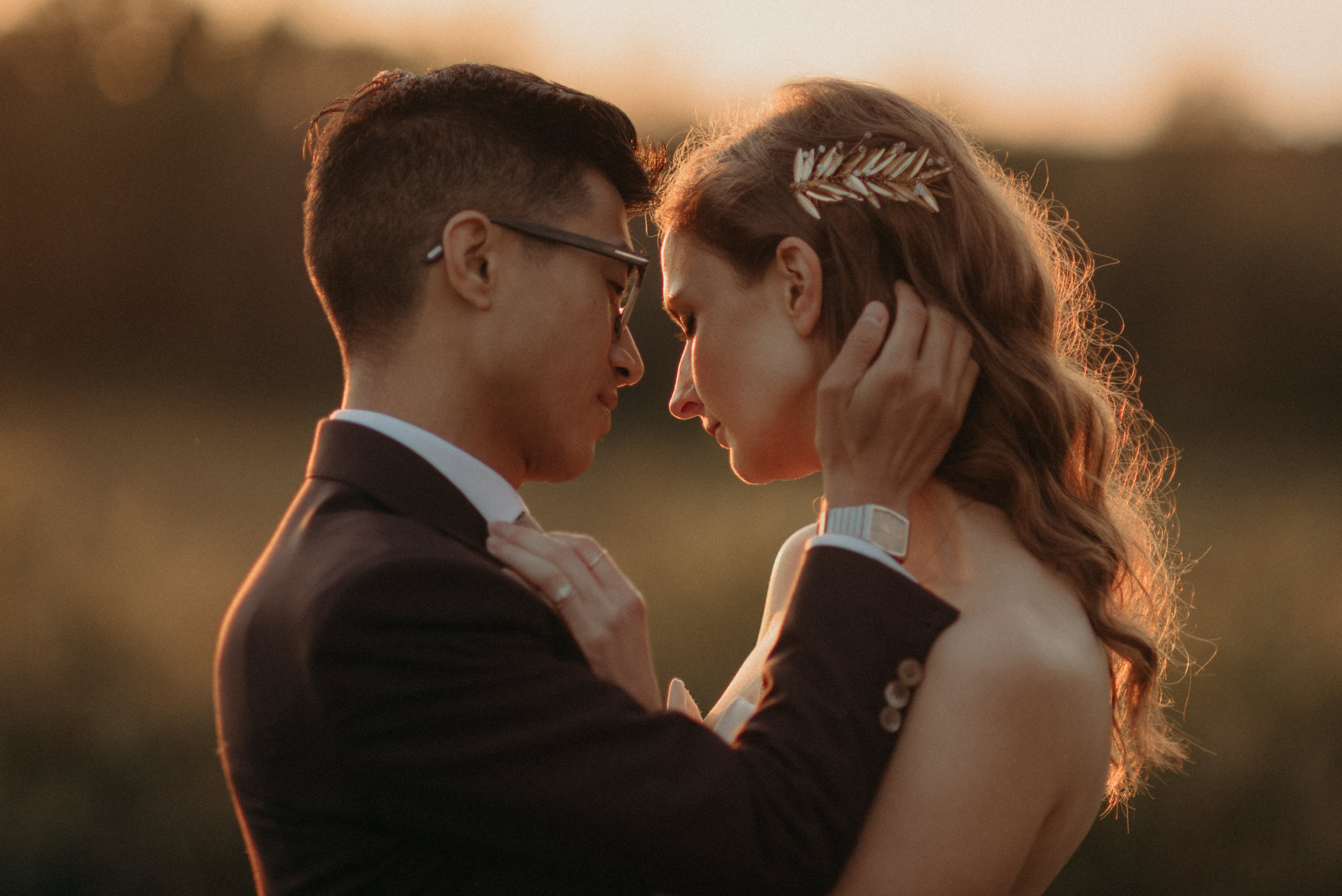 sunset wedding portrait of couple in a field