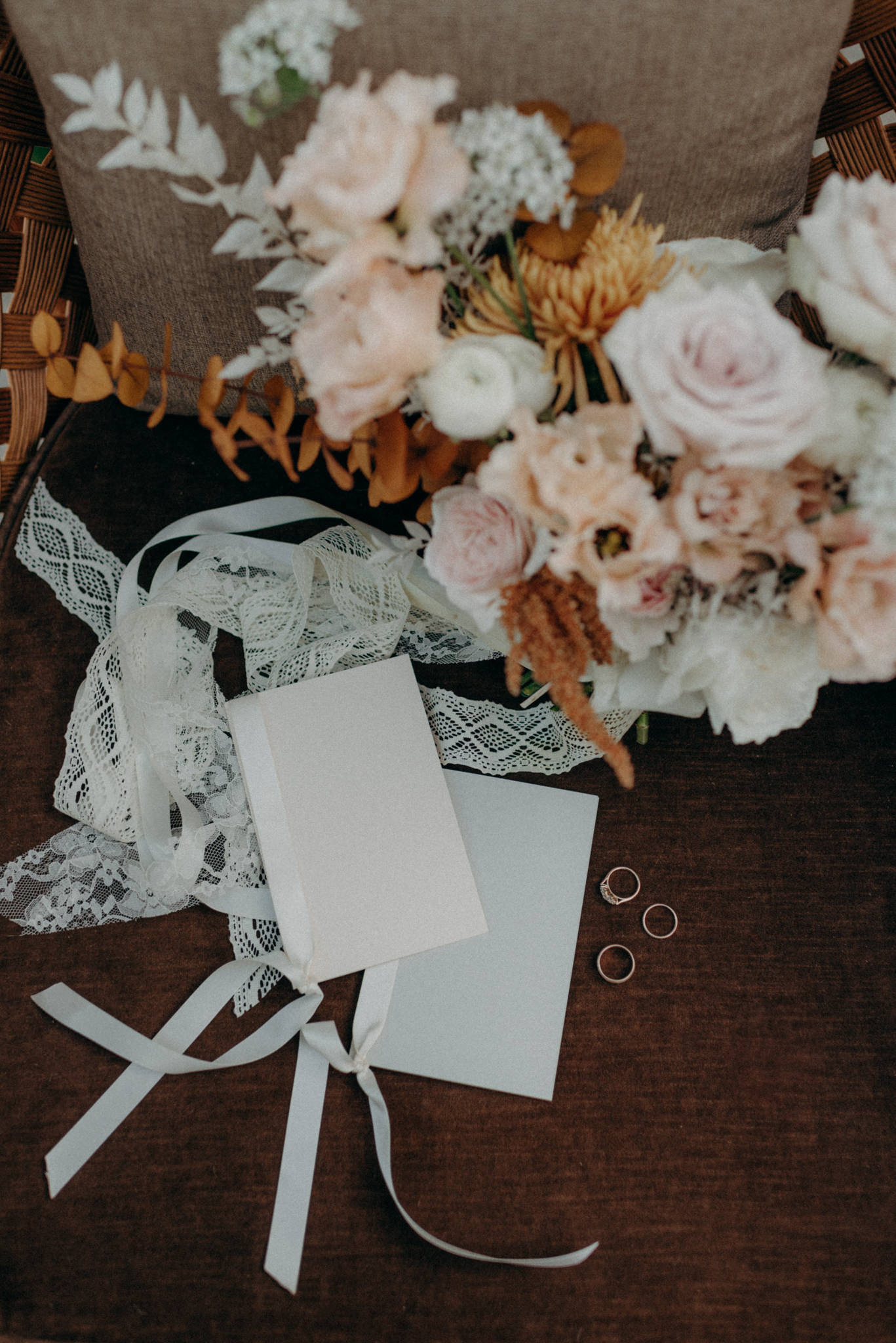 wedding bouquet and rings on chair