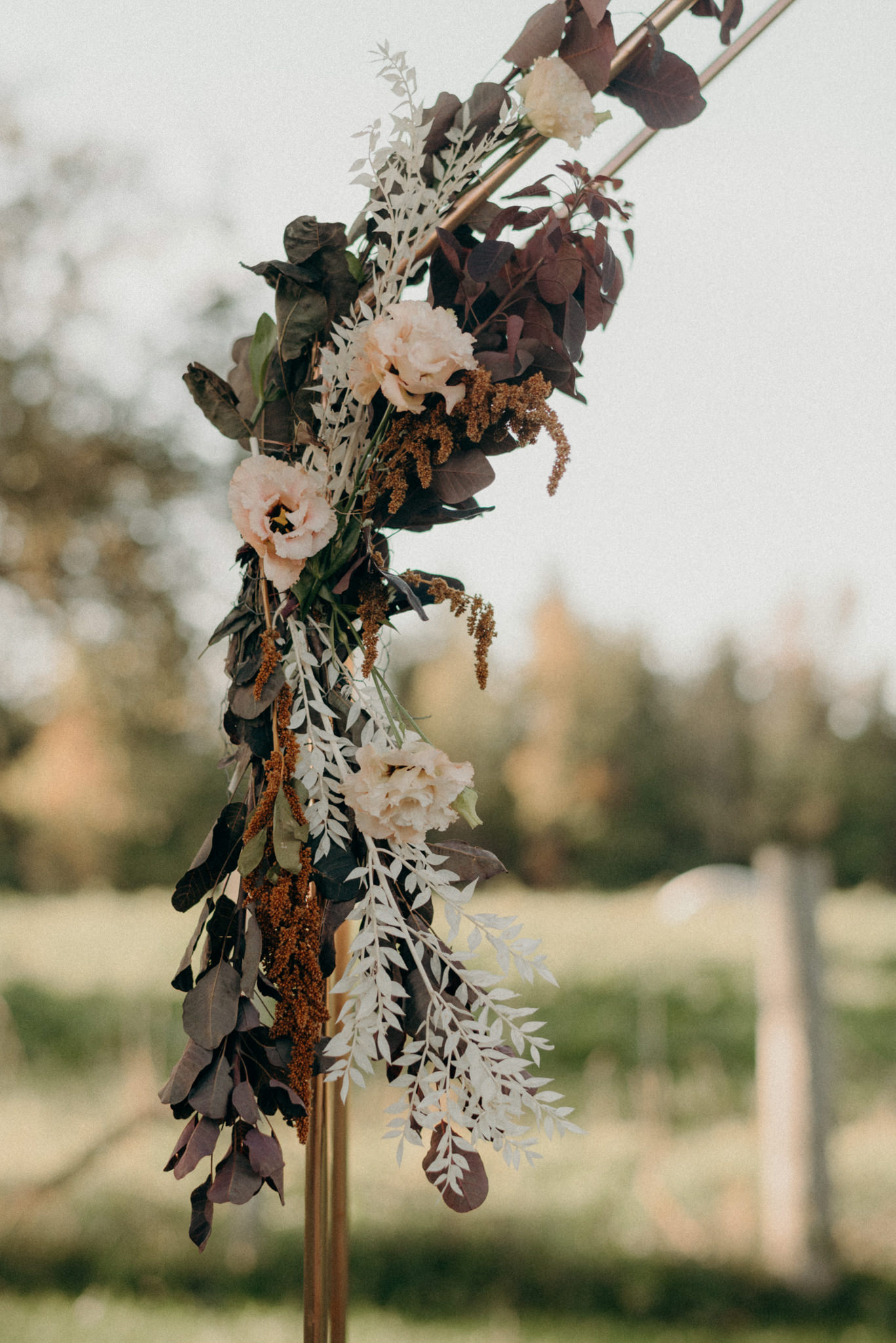 flowers on copper ceremony arch backdrop