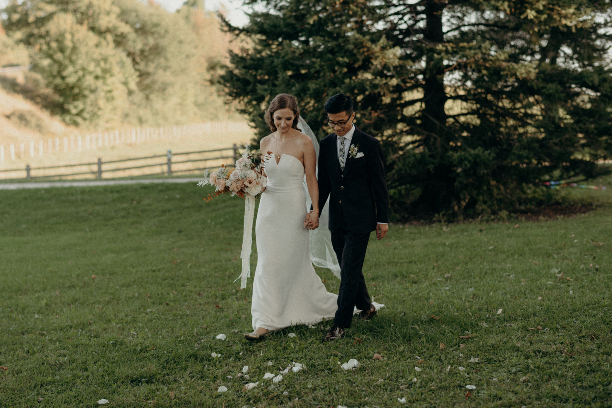 bride and groom walking holding hands down aisle