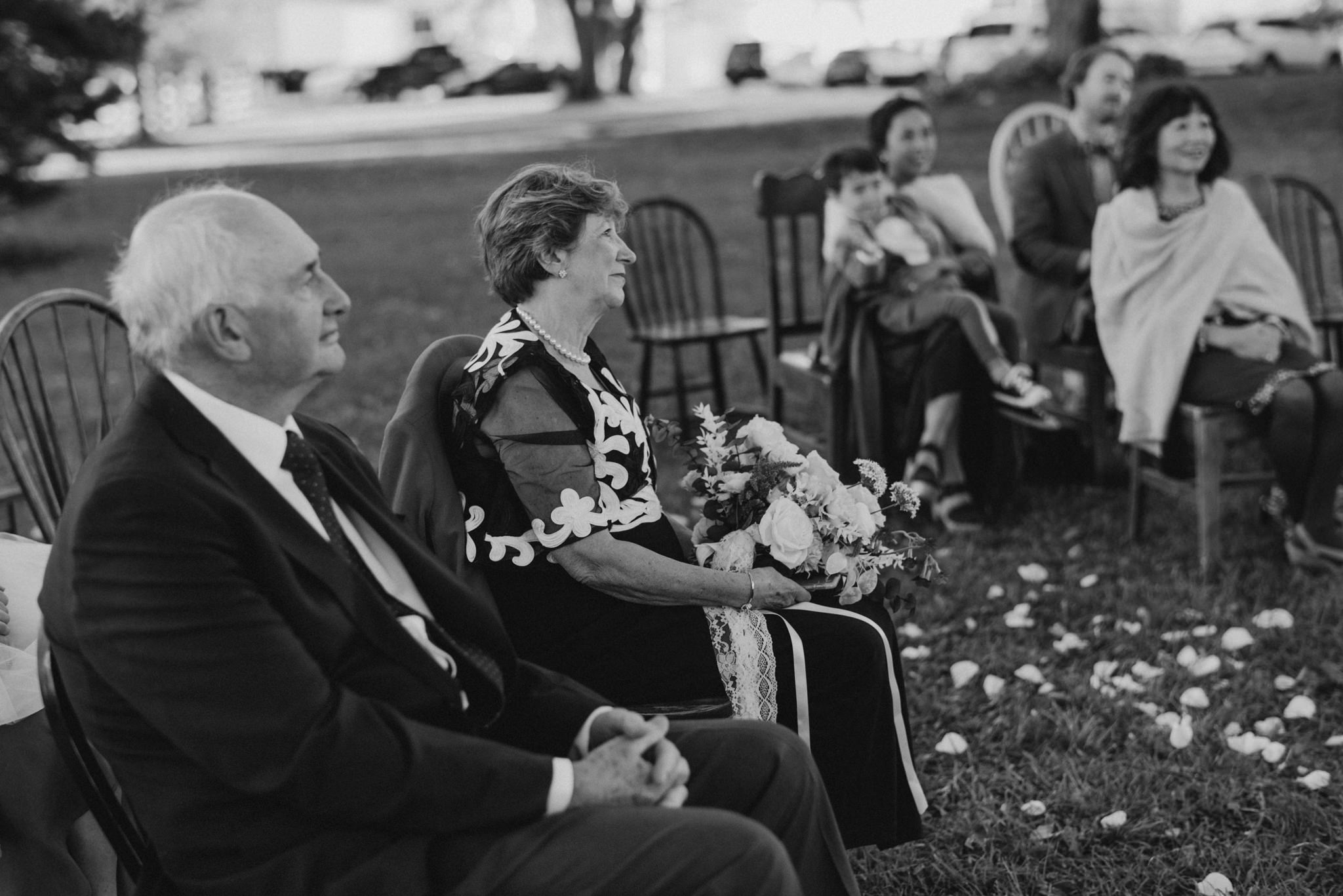 parents smiling as they watch ceremony