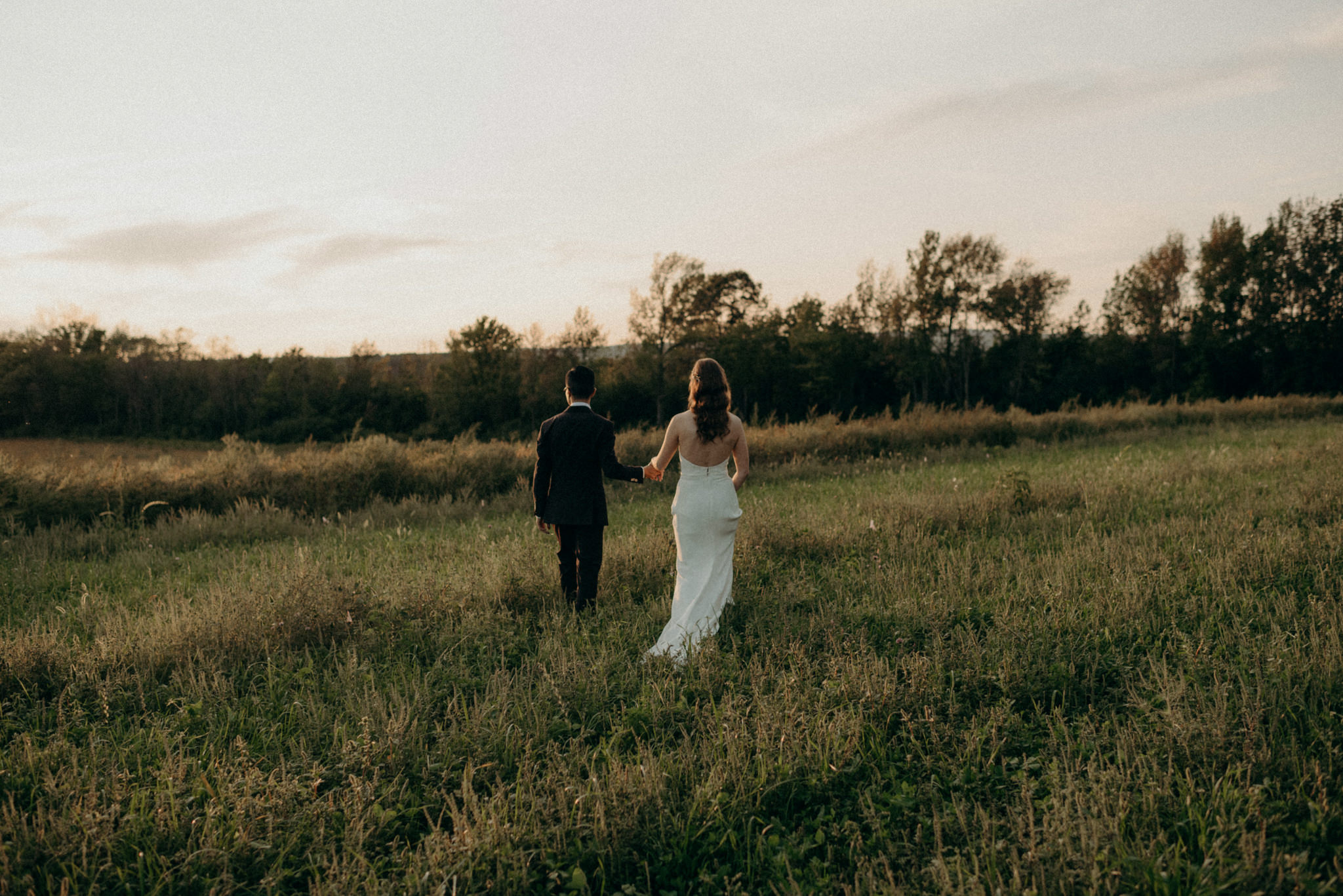 Wedding portraits in a field at sunset. Good Family Farms wedding.