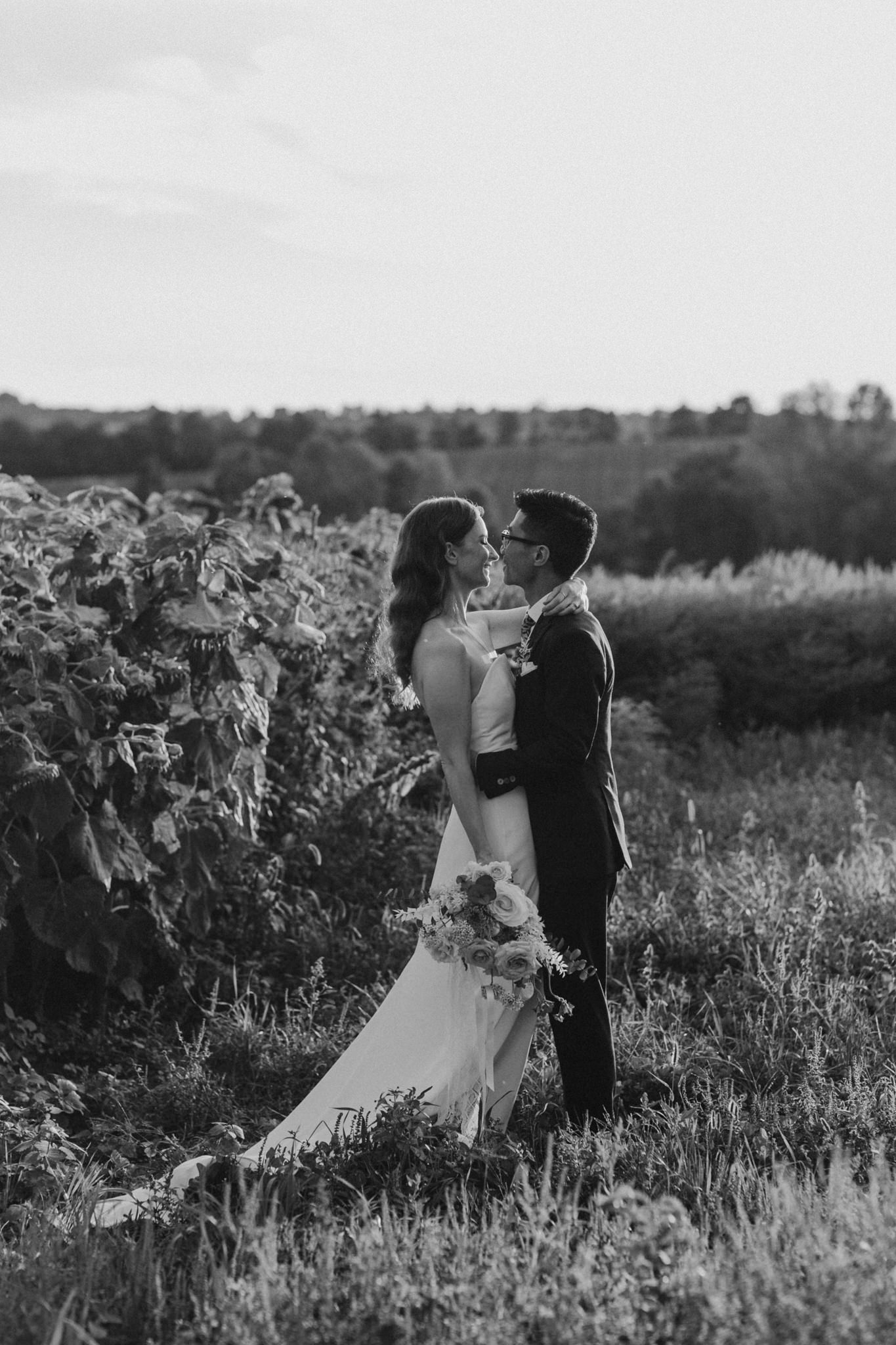 Wedding portraits in a field at sunset. Good Family Farms wedding.