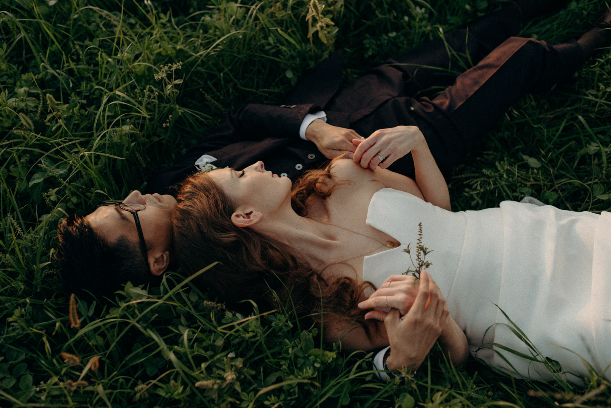 Wedding portraits lying in a field at sunset. Good Family Farms wedding.