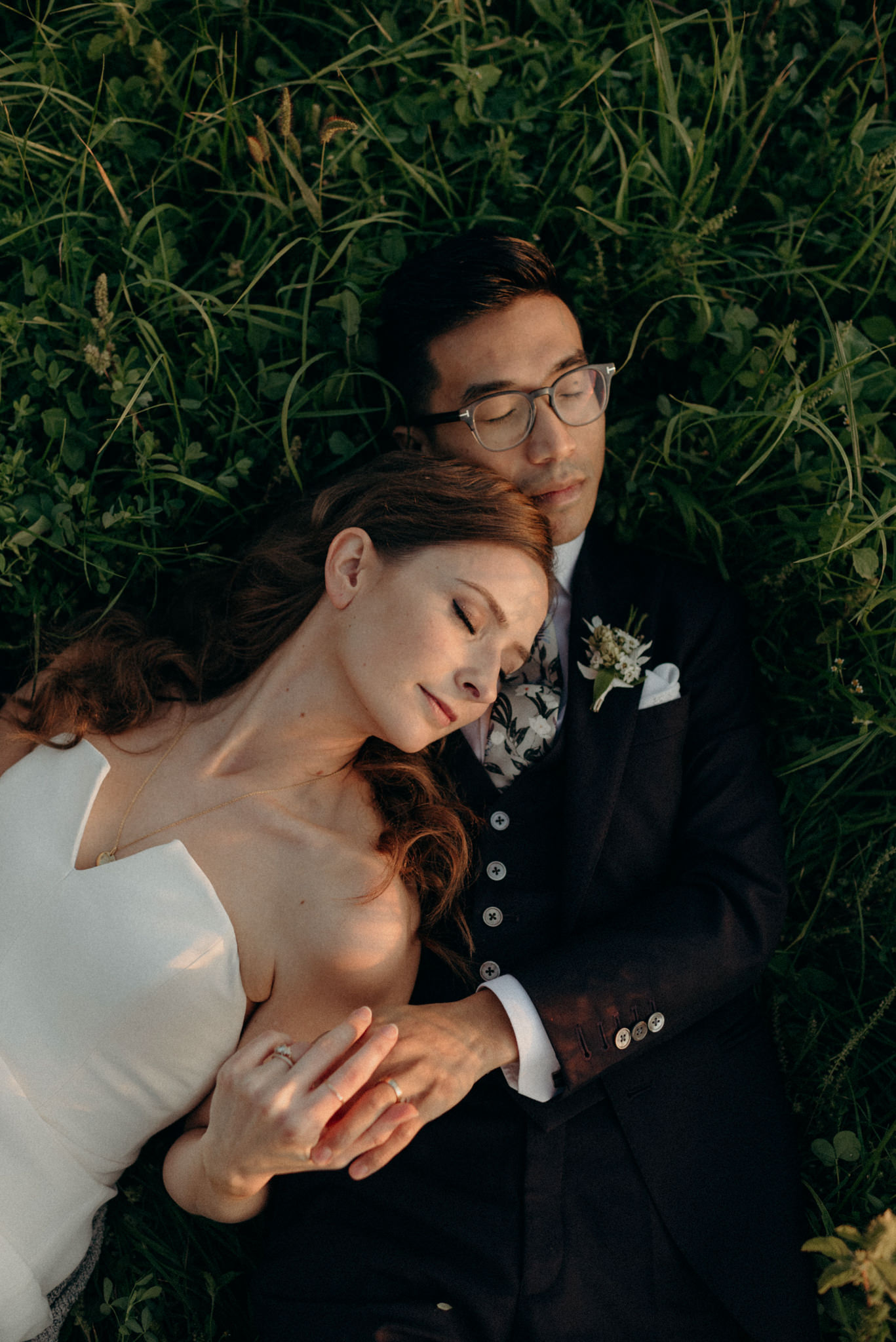 Wedding portraits lying in a field at sunset. Good Family Farms wedding.