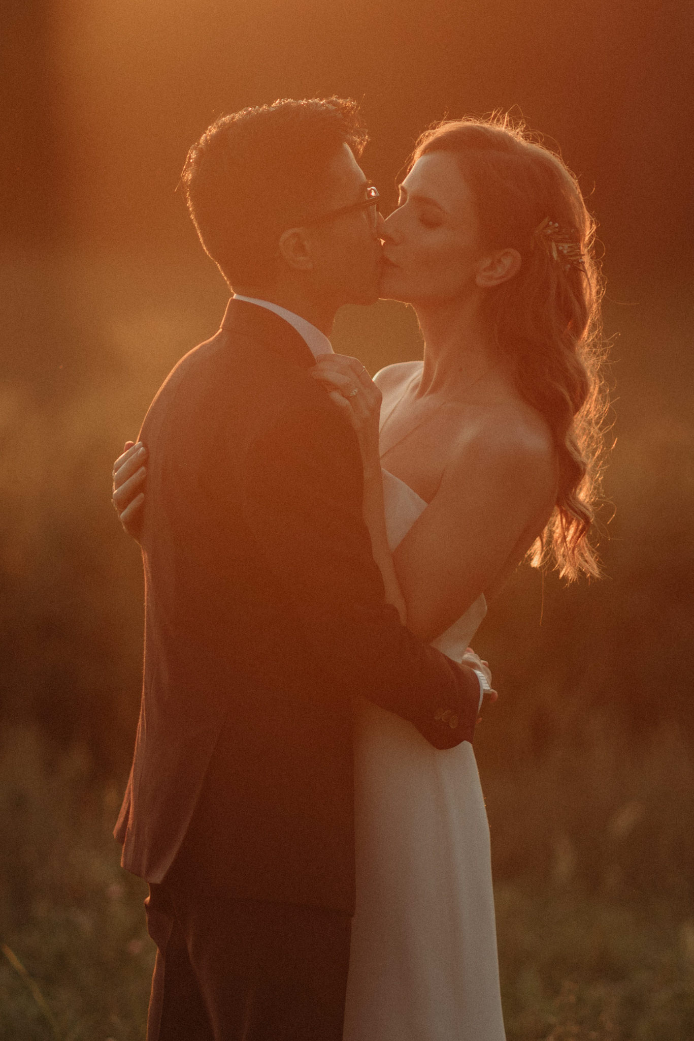 Wedding portraits in a field at sunset. Good Family Farms wedding.