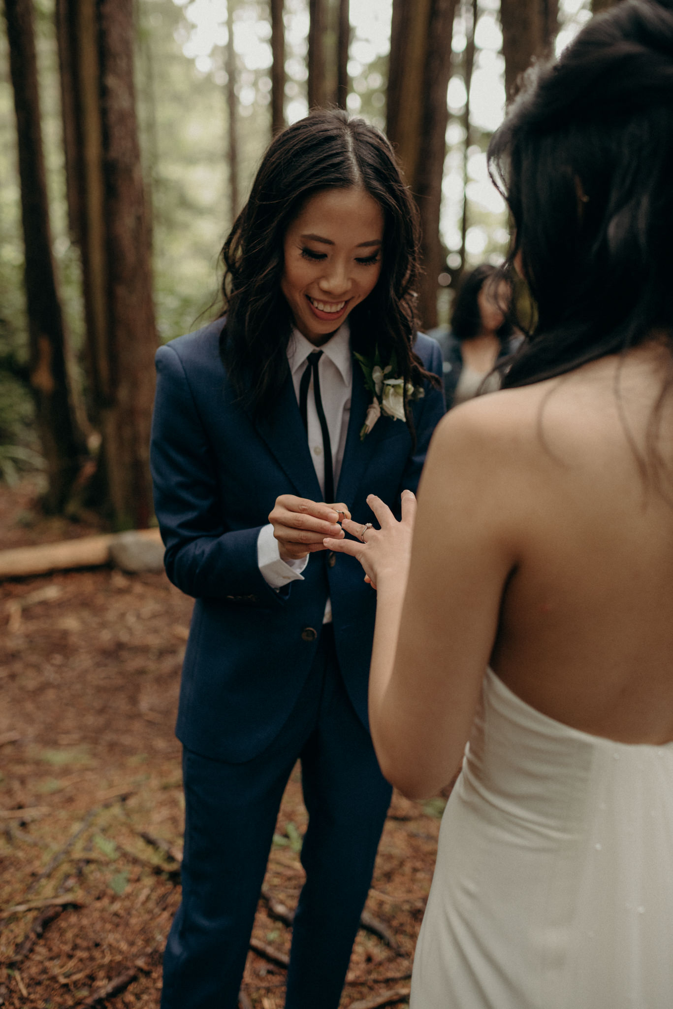 bride smiling as they exchange rings, same sex elopement