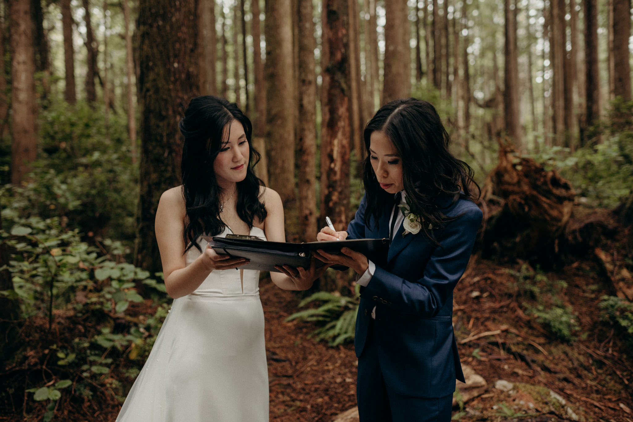 brides signing marriage license in forest