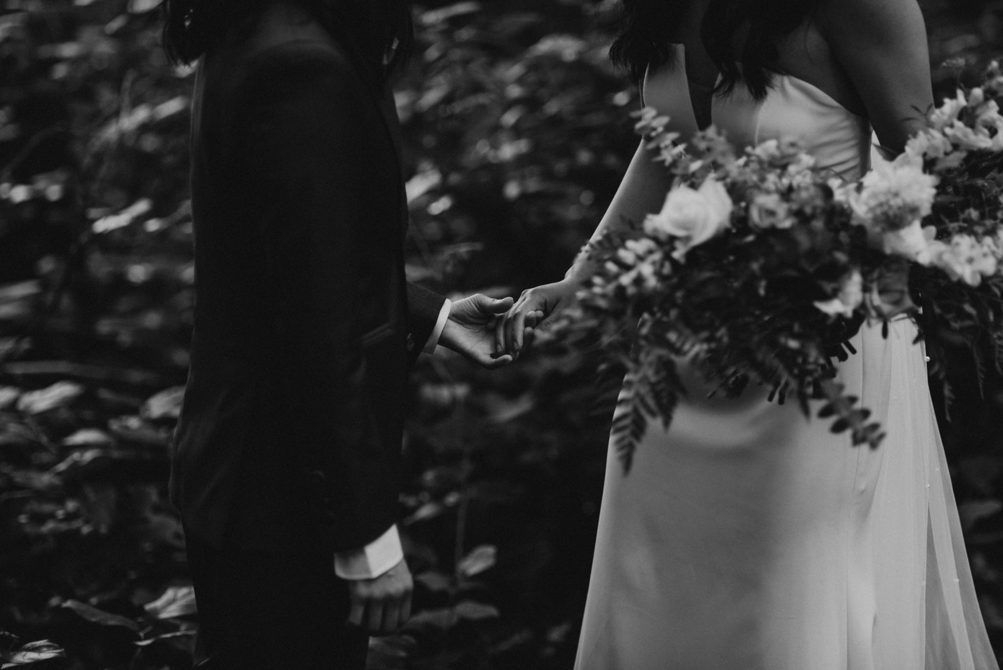 brides holding hands, black and white