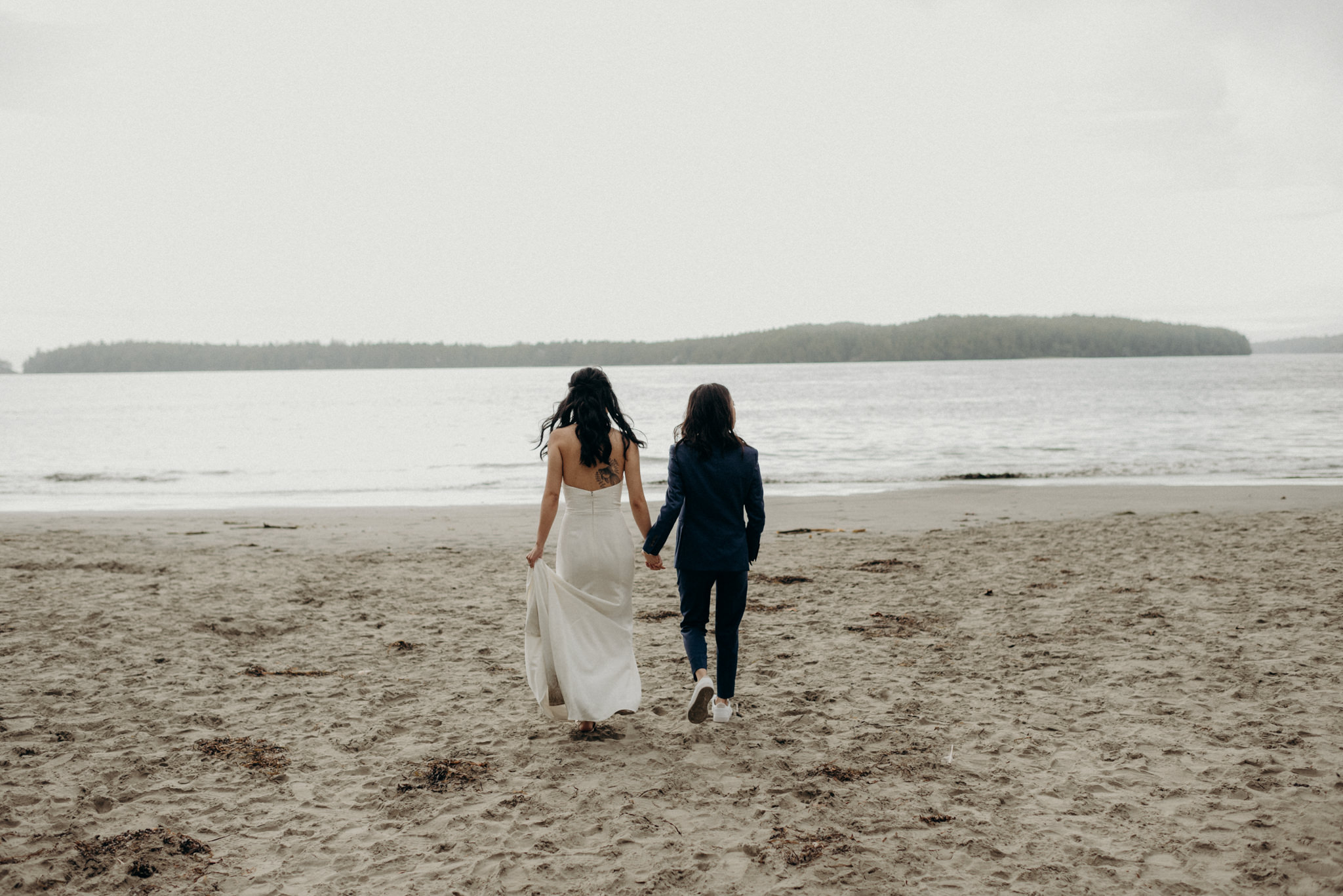 brides walking on beach together