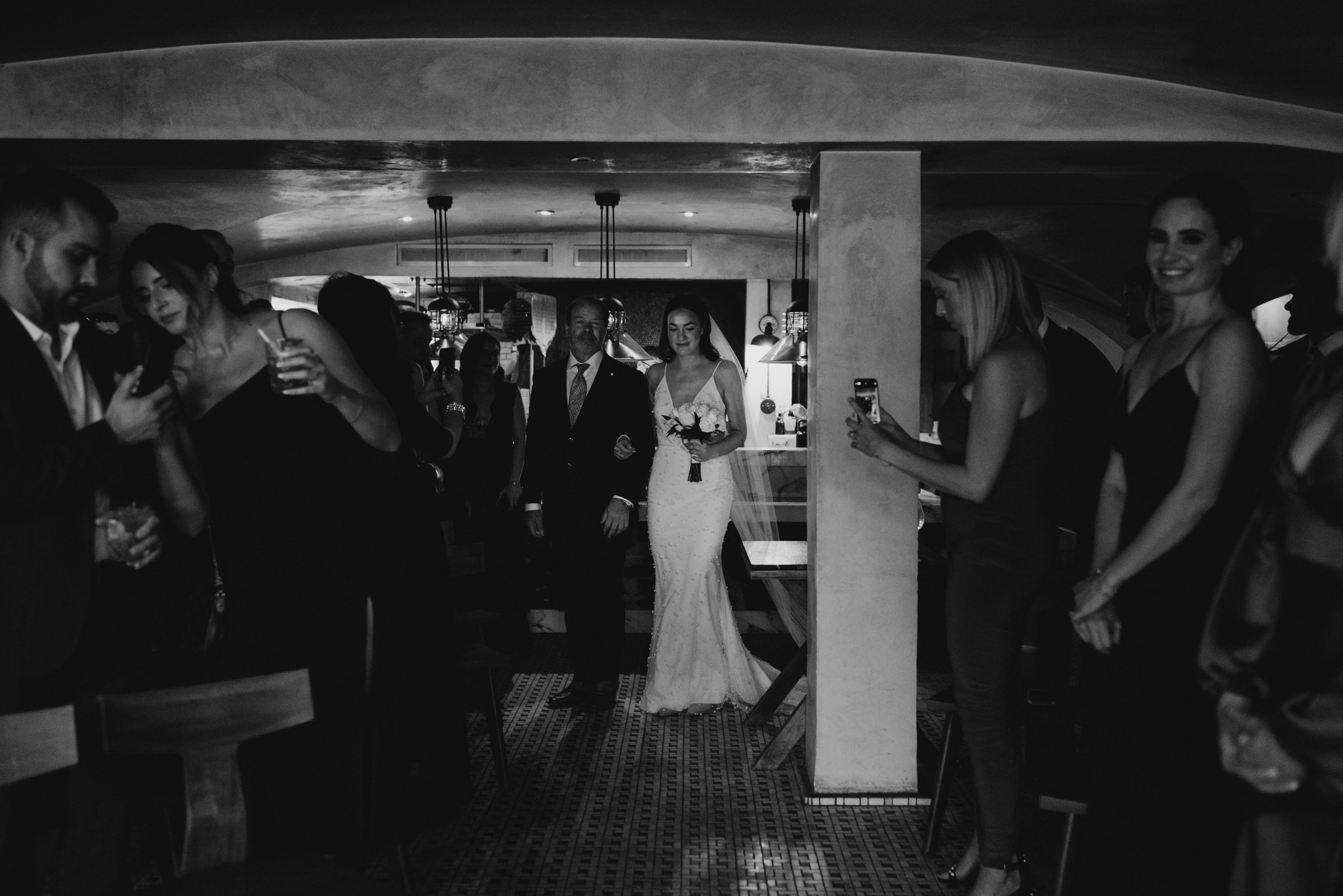 bride walking down aisle at restaurant wedding